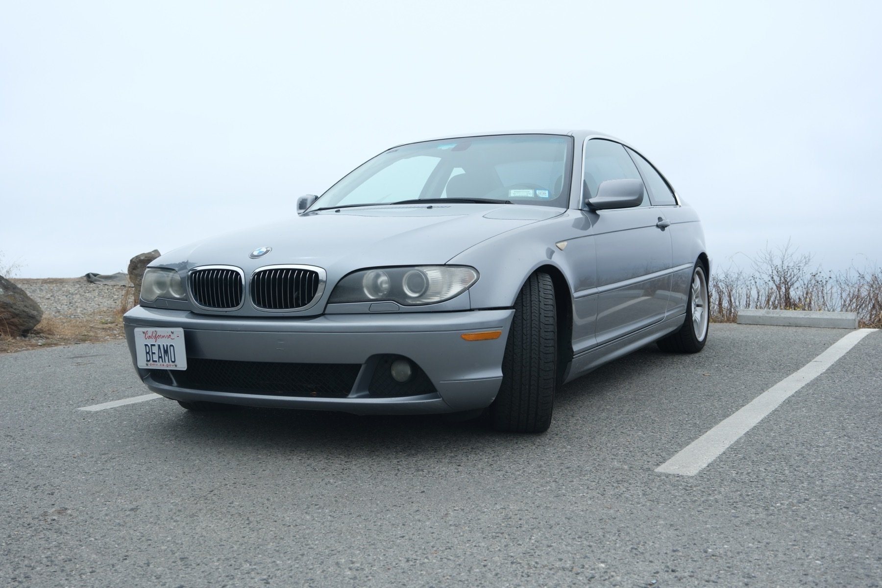2004 BMW 330Ci in Silver Grey Metallic, front three quarter on the coast