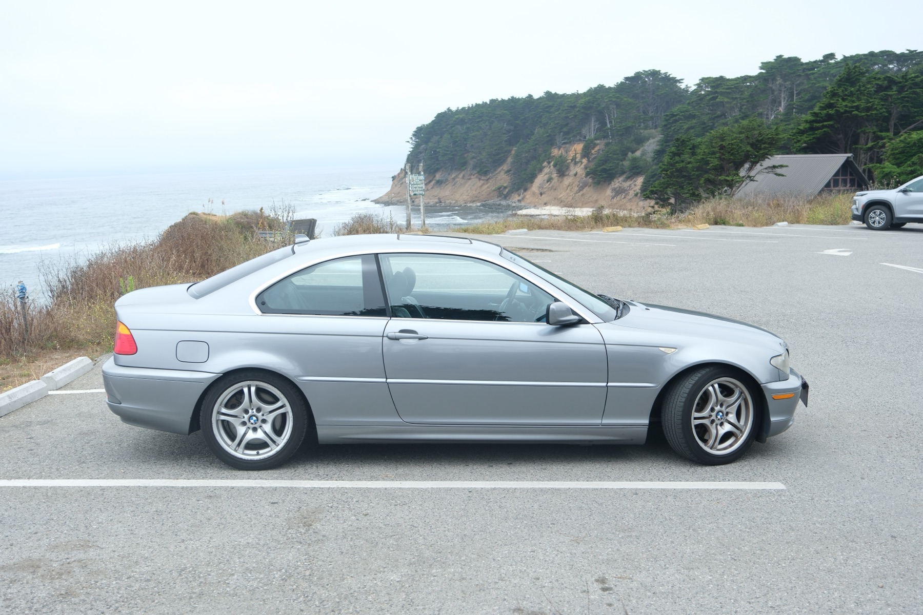2004 BMW 330Ci in Silver Grey Metallic, profile view on the Pacific coast